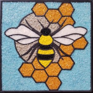 glass mosaic of a bee on a honeycomb