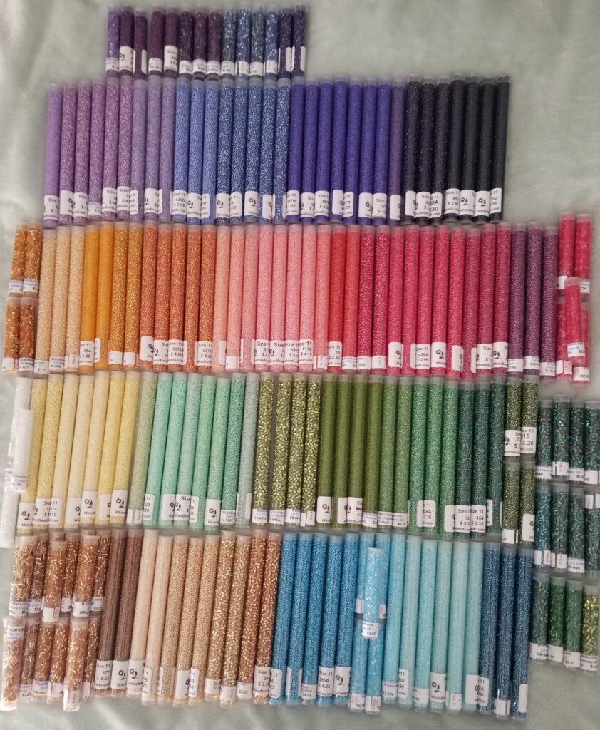 Glass seed beads arranged by color, the palette I use for painting with beads